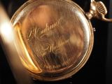 a close up of a gold pocket watch on display