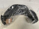 a black object wrapped in plastic on a white surface