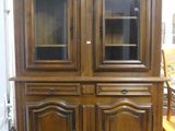 an image of a wooden china cabinet with glass doors