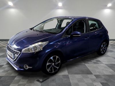 a blue car is parked in a room with a checkered floor