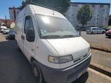 a white van that is parked on the side of the street