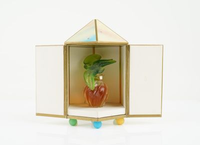 a small glass vase with a plant inside of it