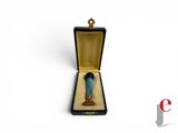 a small figurine of a woman in a box