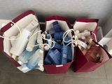 three bags with items in them sitting on the floor
