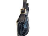 a black purse with a gold buckle on the front