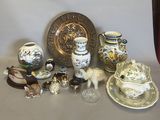 many different types of vases and plates on the table
