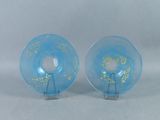 pair of blue glass plates with gold leaf designs on them