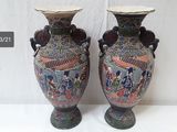 two vases that are sitting on a table
