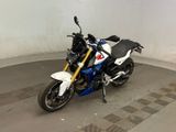 a white and blue motorcycle parked inside of a building
