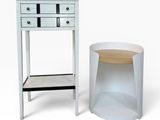 a white table with a drawer next to it and a small table with a drawer