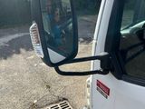 a white truck with a mirror on the side of it ' s side