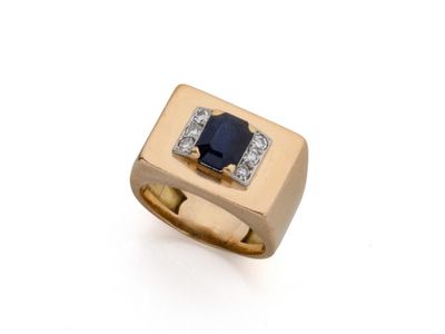 gros plan d'une bague en or avec un saphir et des diamants