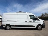 a white van parked in a parking lot with a blue sky in the background