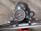a close up of a motorcycle with a speedometer on it ' s handlebar