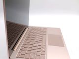 a laptop computer that is open on a white surface