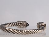 a close up of a bracelet on a table with a white background