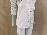 michael jackson ' s white shirt and pants on display in front of a beige backdrop