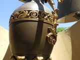 a black and gold vase with a bird on it