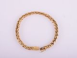 a gold bracelet with a clasp on a white background
