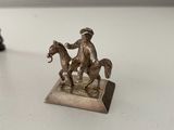 a statue of a man riding a horse next to a statue of a man on a horse