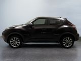 the black nissan juke suv is parked in a garage
