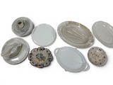 a lot of plates and bowls on a white surface