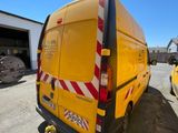 a yellow van that is parked in a parking lot