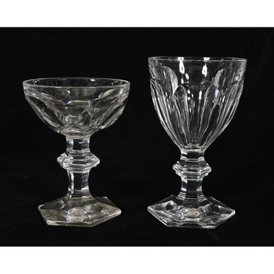 two clear glass goblets sitting on top of a black table