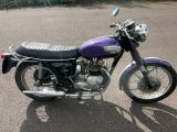 a purple motorcycle that is parked in a parking lot