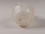 a white glass vase with a pattern on it