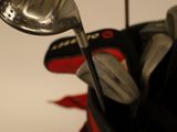 a close up of a golf bag with a golf club in it