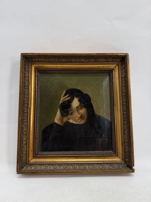 portrait of a man in a black coat holding his head in his hands