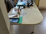 a desk with a computer on it in the corner of a room