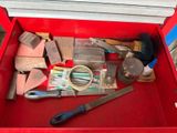 a red tool box with tools in it and a pair of scissors in it