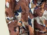 a close up of a shirt with a camouflage pattern on it