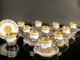 a lot of cups and saucers that are on the table