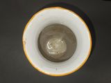a brown and white bowl sitting on a table