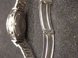a watch that is laying on a black surface