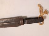 a knife with a rope on the end of it