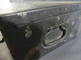 a black suitcase sitting on a table with a handle