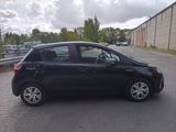 a picture of a small black car parked on the side of the road