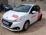 a small white car with a red sticker on the side of it