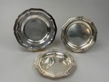 three silverplated dishes on a white background
