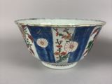 a blue and white bowl with flowers on it