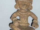 a small statue of a man with a hat on his head