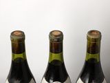 three bottles of wine that are sitting on a table