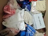 a box full of clothes and a sign in it