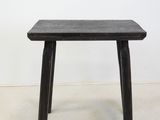 an image of a small wooden table with a black top