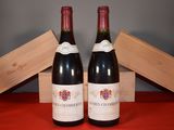 two bottles of wine sitting next to each other on a table