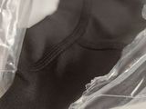 a plastic bag with a black shirt inside of it